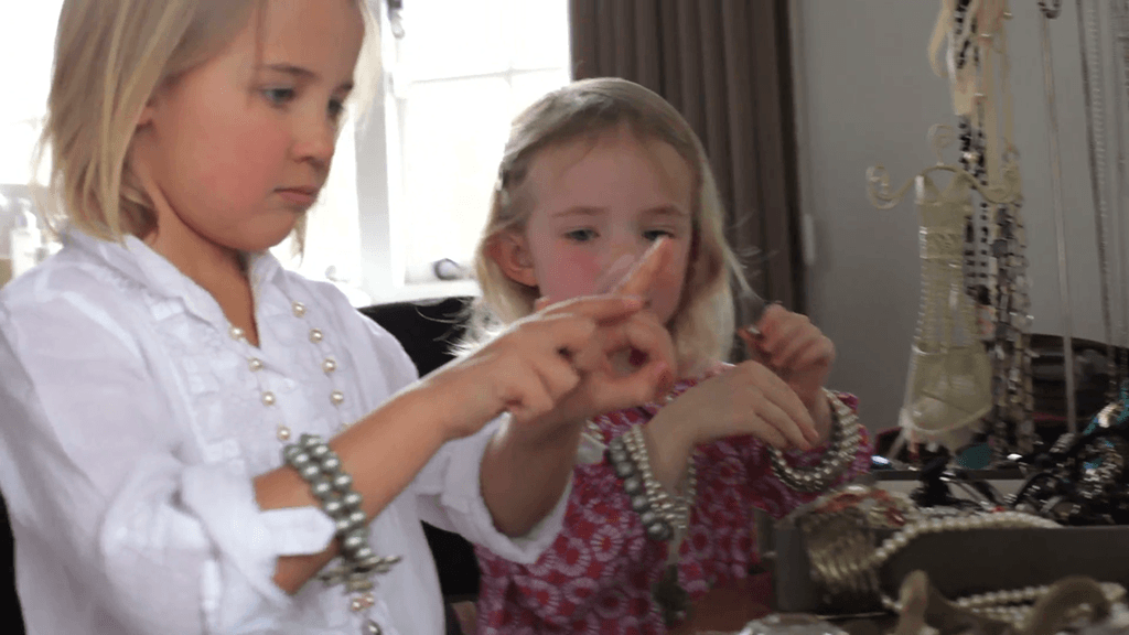 two girls filing nails and playing with jewelry in bedroom n1llurl5y  F0000