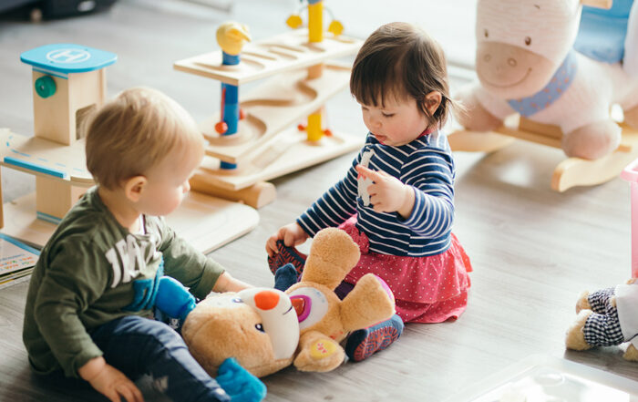 toddler playing with small toys