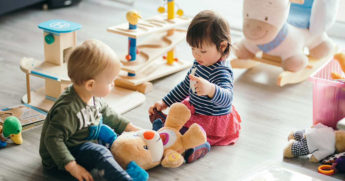 toddler playing with small toys
