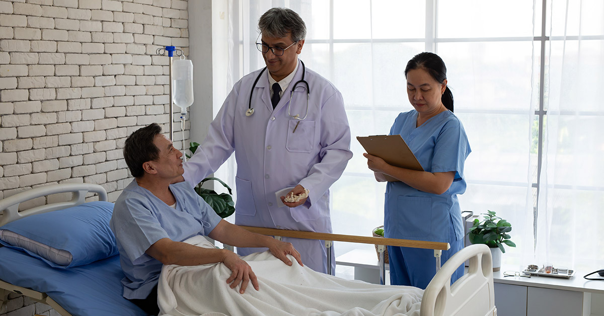 Hospital patient speaking with a doctor and nurse after surgery, illustrating medical malpractice and permanent disability concerns.